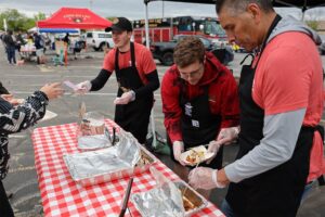 Guys Who Grill team serving BBQ.