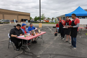 Guys Who Grill presenting their BBQ to the judges.